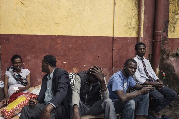 Migrants rest next to the Tiburtina train station in Rome on Sunday. Hundreds of migrants, many from Ethiopia, Somalia and Eritrea, arrived in recent months on boats from Libya. They were brought to Italy after being rescued at sea.